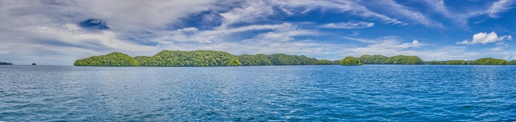 Panoramic view over turquoise blue water to a tropical island in Palau