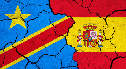 Flags of Congo - Democratic Republic and Spain on cracked surface - politics, relationship concept