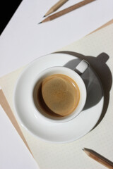 Espresso Coffee on Office Desk with Papers, Pencils. Coffee Break. 