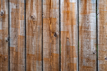 Wooden background of several old boards nailed side by side.
