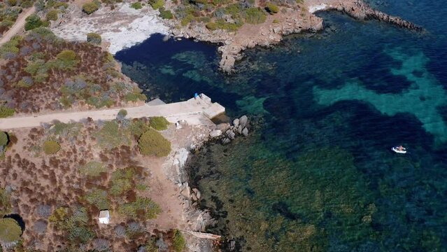 Aerial view of a little boad moving to the shore - Sardinia