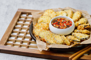 fried eggplant, Flatten the eggplant and dredge in the tempura flour, shaking off any excess. Mix the tempura flour, egg, and water to make a tempura batter. Once the oil is hot, coat the trimmed eggp