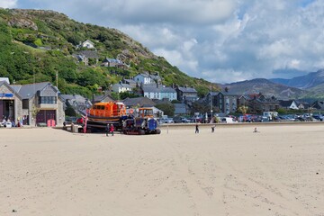 Fototapeta na wymiar The town and the rescue ship, seen from the beach in Barmouth, UK