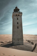 Picturesque lighthouse located in the sand dunes of Northern Denmark