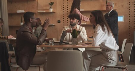 Multicultural coworkers talking over business issues at the lounge area, camera trucking