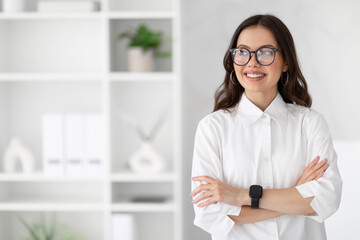 Cheerful young caucasian business woman in white shirt and glasses enjoys professional occupation,...