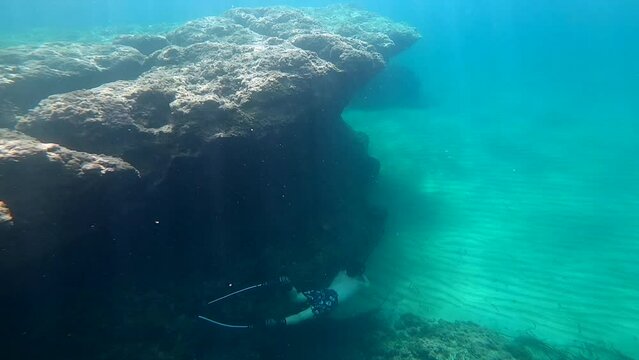 free dive athlete snorkel Ibiza island mediterranean sea rock formation