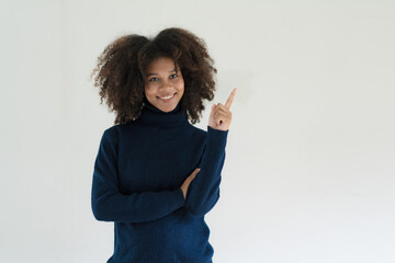 Joyful young professional having a new idea, pointing index finger up. African American businesswoman standing isolated over white background.