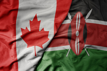 big waving realistic national colorful flag of canada and national flag of kenya .