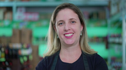 Portrait face of a Portuguese looking woman smiling at camera, caucasian person in 40s