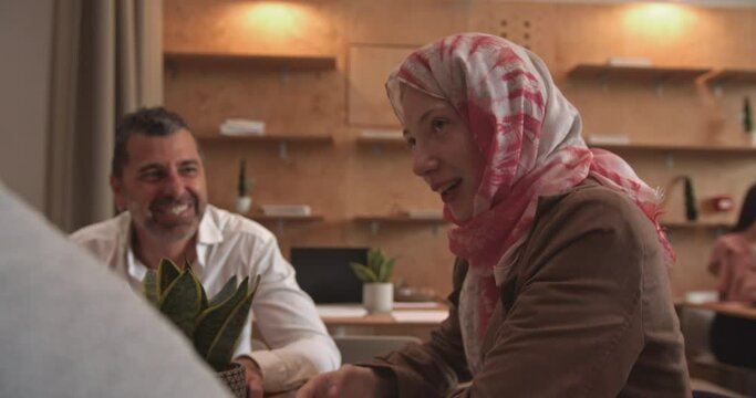 Business people talking and smiling in the cafe bar