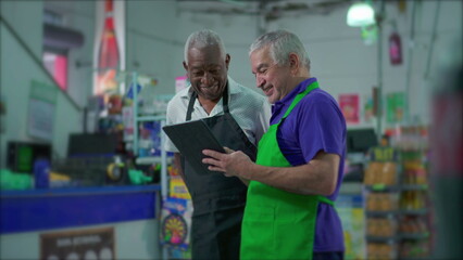 Senior Supermarket Employees with Tablet Device, Teamwork Scene of Older Manager Instructing...