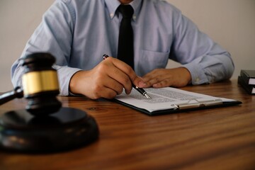 Legal counsel presents to the client a signed contract with gavel and legal law. justice and lawyer...