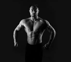 Fototapeta na wymiar Black and white photo of a strong muscular man. Bodybuilding, torso.