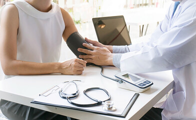 Doctor checking old woman patient arterial blood pressure. Health care