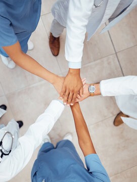 Motivation, teamwork or hands of doctors in hospital for healthcare goals, unity or solidarity together. Clinic, top view or medical nurses with group support, trust or wellness mission in clinic