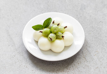 Gooseberry cream jelly pudding, Panna Cotta in the shape of truffles, decorated with fresh...