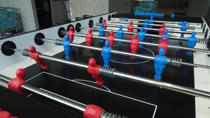Football table or soccer table game with plastic player figurine. Mini Soccer game which famous in past and be collectable item for foosball lover. Play by two hand control each row of player figurine - obrazy, fototapety, plakaty