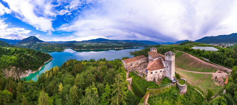  most famous and beautiful medieval castles of northern Italy. scenic Cles  castel- in Trentino , province of Trento. surrouded by fields of apple trees near the lake Santa Giustina