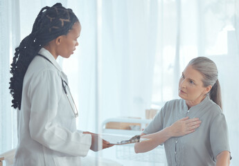 Healthcare, discussion and doctor with elderly patient talking about chest pain problem....