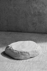 Black and white stone podium display, gray mockup background. Decorative textured stand for beauty products with copy space