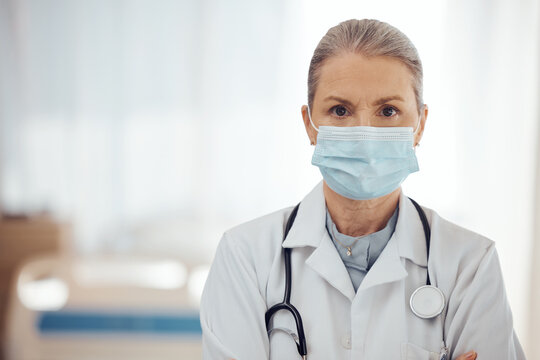 Woman, portrait and doctor with face mask in hospital for medical services, surgery and mockup space. Serious female surgeon, senior therapist and healthcare manager with safety ppe working in clinic