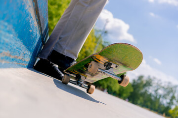 Close-up of a skateboarder's legs with a skateboard while resting between tricks at a city...