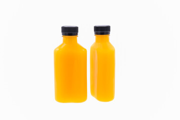 colorful and  fresh orangr juice in a flat plastic bottle with black bottle cap on white background,isolated