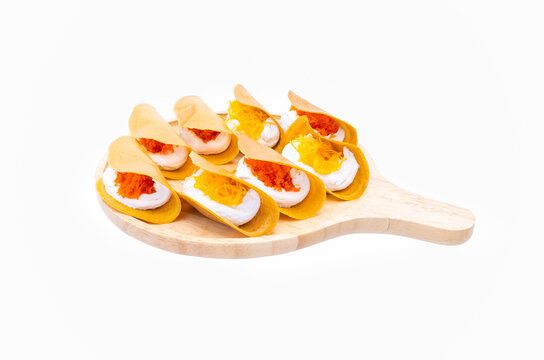  colorful Thai Crispy Pancake in wooden plate on white background close up, thai style desserts