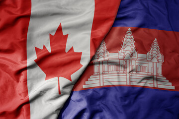 big waving realistic national colorful flag of canada and national flag of cambodia .