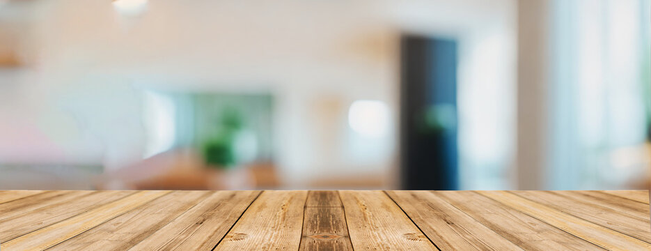 Empty wooden table and bokeh lights blurred outdoor office background.