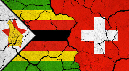 Flags of Zimbabwe and Switzerland on cracked surface - politics, relationship concept