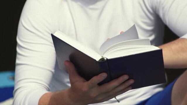 a man is reading a book. close-up of the book. turn the pages of a book. High quality Full HD video recording