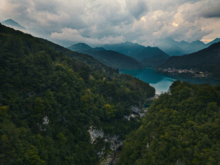 Fototapeta na wymiar Aerial shot of Barcis lake and its dam. Emerald water, sky with clouds