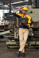 Caucasian engineer using a laptop in a factory. man working in plastics factory.