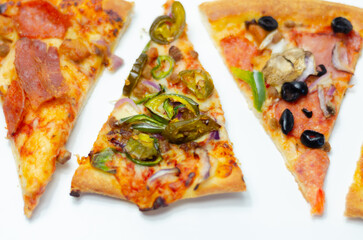 Different slices of pizza with pepperoni, ham, mushrooms, mozzarella and olives