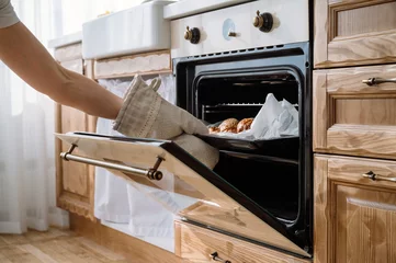Foto op Plexiglas Brood housewife baking fresh homemade bun for breakfast