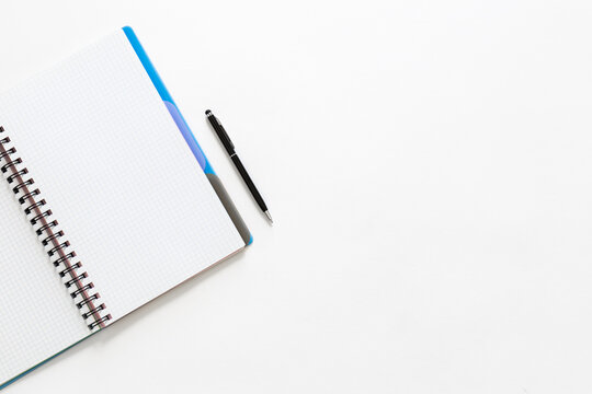 Notepad and pen on a white background, top view.