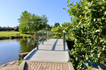 The old wood bridge in the park on a sunny day.