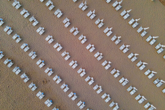 Aerial view of umbrella on the beach along the shoreline, Capaccio, Paestum, Campania, Italy.