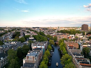 Obraz premium Canal in Amsterdam, trees, sky, clouds, old buildings, architecture, Netherland, view, landscape