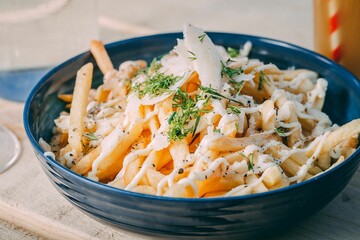 Bowl of french fries topped with sauce
