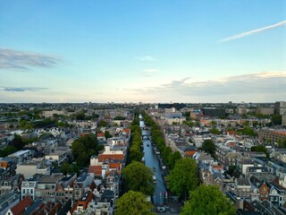 Obraz premium Canal in Amsterdam, trees, sky, clouds, old buildings, architecture, Netherland, view, landscape