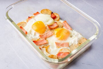 Delicious breakfast in a glass dish with bacon and eggs