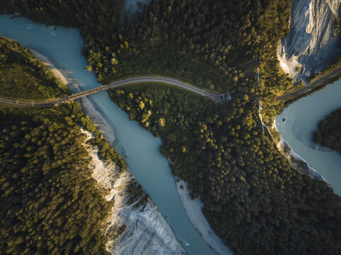 Aerial drone view of a canyon filled by a glacier river crossed by a railroad, Rheinschlucht, Flims, Graubunden, Switzerland.