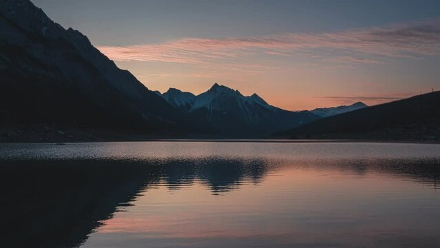 Sunrise over Medicine lake with rocky mountains and lake reflection in the morning at Jasper national park