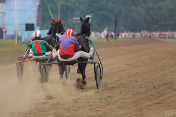 Horses and riders running at horse races