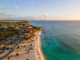Aerial view of Arashi Beach at sunset in Aruba.