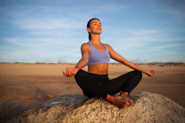 Fototapeta na wymiar Smiling millennial caucasian lady practice yoga, enjoy breathing exercises, meditate on sea beach