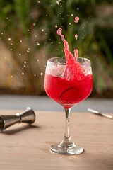 Refreshing red cocktail with a splash